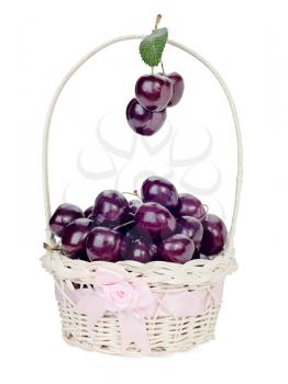 sweet cherry in a wicker gift basket isolated on white
