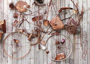 Still-life of rusty metal items on wooden background.