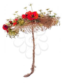 Decorative umbrella from burlap, mats and artificial poppy flowers. Closeup.