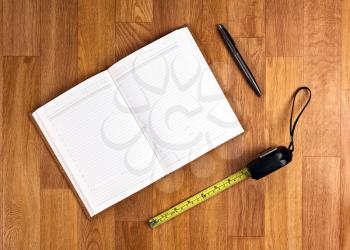 Blank Notepad with Office Supplies on Wooden Table. Above Wiew.