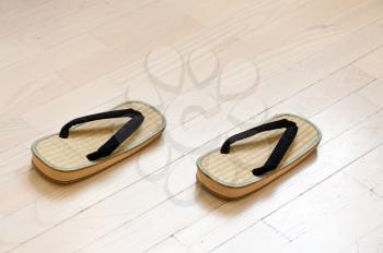 Pair of Traditional Japanese Sandals on Old Wooden Floor. Selective Focus.