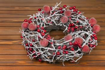 Christmas Wreath with Decorations on Wooden Background. Closeup.