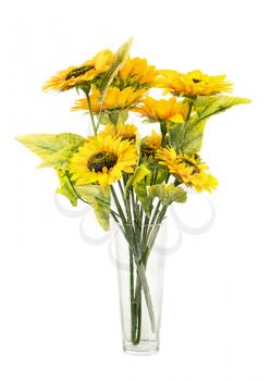 Composition of bright artificial sunflowers in glass vase isolated on white background. Closeup.