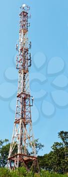 Telecommunication towers with deep blue sky. Closeup.