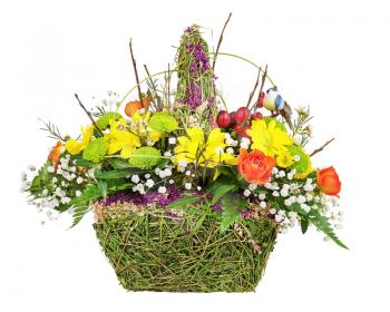 Flowers bouquet arrangement centerpiece in wicker basket isolated on white background.