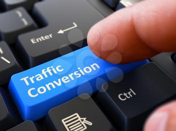 Traffic Conversion - Written on Blue Keyboard Key. Male Hand Presses Button on Black PC Keyboard. Closeup View. Blurred Background. 3D Render.