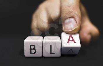 BLA Changes to BLA - False promises Concept. Hand Turns a Dice and Changes the Word bla to bla.