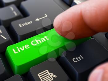 Live Chat - Written on Green Keyboard Key. Male Hand Presses Button on Black PC Keyboard. Closeup View. Blurred Background.
