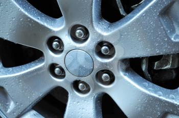 Close up shot of an auto wheel with water drops on its surface