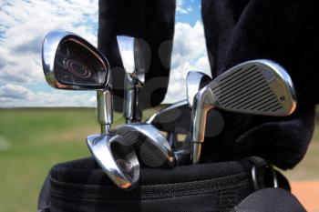 Golf bag with clubs against a beautiful blue sky