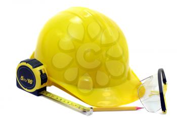 Macro shot of a yellow helmet and tools