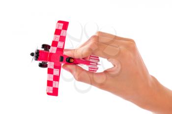 MAcro shot of the hand of a kid holding a toy plane isolated on white