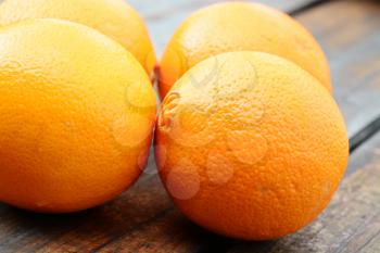 Macro shot of fresh oranges on a wooden table