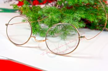 Antique gold reading glasses over a christmas card