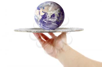 Hand holding a silver tray with the world on it