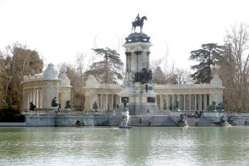 MADRID-SPAIN-FEB 19, 2019: The Monument to Alfonso XII is located in Buen Retiro Park (El Retiro), Madrid, Spain. The monument is situated on the east edge of an artificial lake near the center of the park.