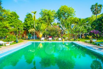 Swimming pool and villa in tropical garden, Myanmar