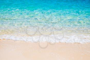 Tropical white sand beach and blue sea wave