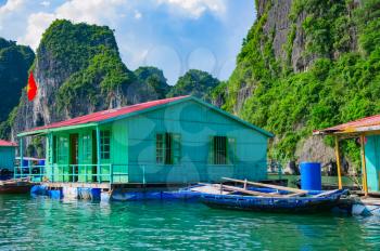 Floating fishing village near mountain islands in Halong Bay, Vietnam, Southeast Asia