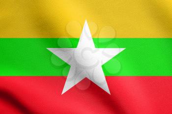 Flag of Myanmar waving in the wind with detailed fabric texture. Myanmar national flag.