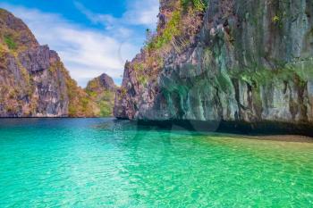 Beautiful tropical landscape with blue lagoon and rocky island, El Nido, Palawan, Philippines