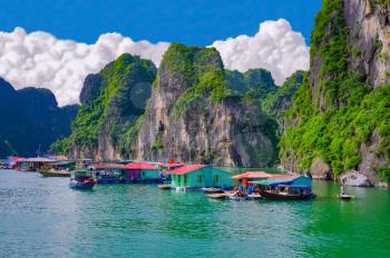 Floating fishing village near rock islands in Halong Bay, Vietnam, Southeast Asia. UNESCO World Heritage Site.