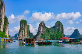 Floating village and rock islands in Halong Bay, Vietnam, Southeast Asia. UNESCO World Heritage Site.