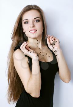 Beautiful young woman holding a black caviar