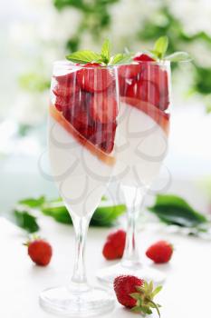 cream jelly with strawberries in a glass