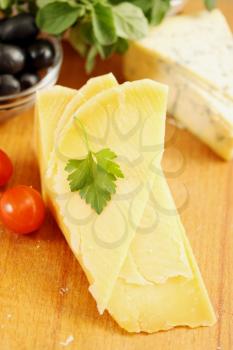 a piece of parmesan cheese with cherry tomatoes