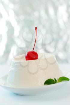 dessert of ricotta cheese with cocktail cherry
