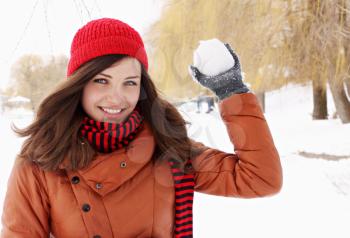 woman in a red cap throwing snowball