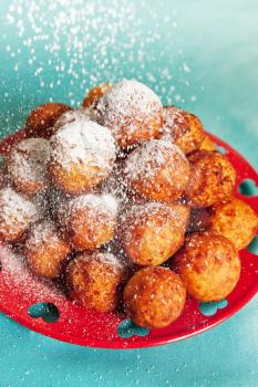 Fried cheese balls sprinkled with powdered sugar