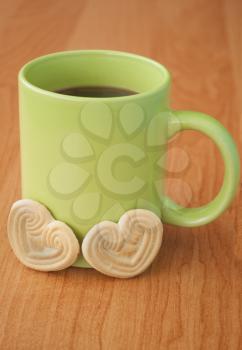 Cup of coffee and cookies in the shape of heart