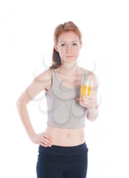 Athletic girl with a glass of juice on a white background.