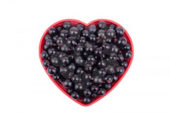 Currants in a dish in the shape of a heart.
