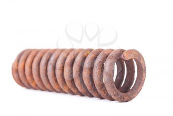 Old rusty metallic spring on white background.