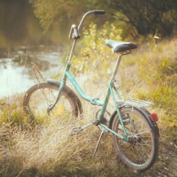 Little Green Bicycle Standing On Green Summer Meadow, Park, Outdoor