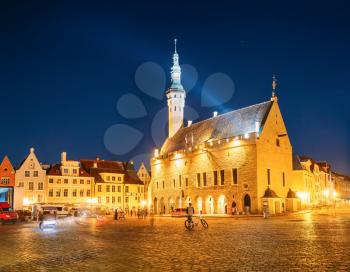 Tallinn, Estonia. Town Hall Square - Raekoja Plats. Famous Landmark In Evening Night Illumination Under Blue Sky.