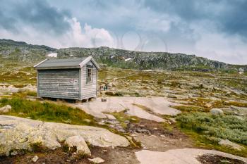 Norwegian mountains landscape. Small old wooden guest house. Travel and hiking