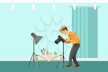 Photographer making shot of still life composition. Man with camera taking photo, teapot near fruits on table under spotlight vector studio room interior