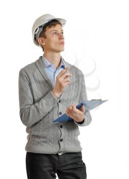 builder in a white protective helmet and with a clipboard looks upward and thinking. isolated on white