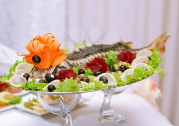 Dish of sturgeon with beautiful design with fruit and vegetables
