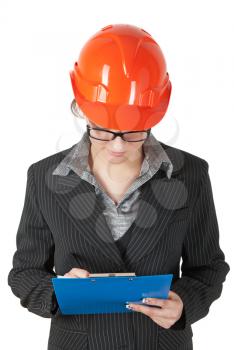 female superintendent in the construction helmet records the tablet