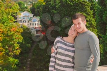 young couple on the background of a beautiful home