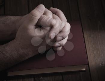tie palms with cross fingers closeup on the Bible during prayer