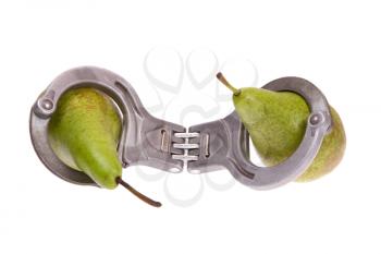 Pears caught in handcuffs on a white background