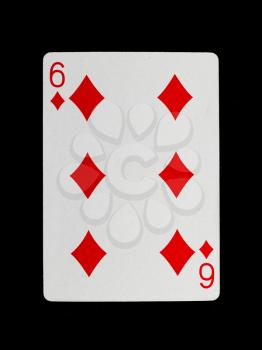 Old playing card (six) isolated on a black background