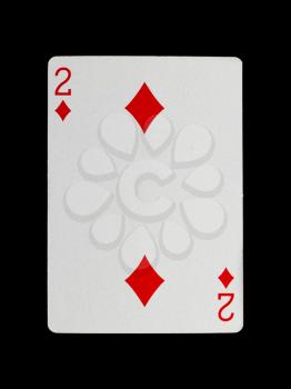 Old playing card (two) isolated on a black background