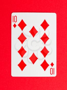 Old playing card (ten) isolated on a red background